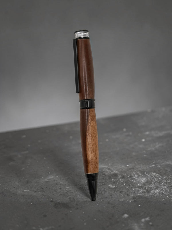 Anderson Woodworks handcrafted wooden ballpoint pen with rich hardwood grain, matte black accents, and silver top.