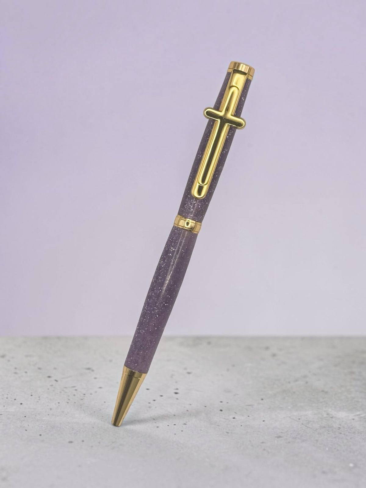 Anderson Woodworks lavender speckled writing pen with gold-tone accents and a distinctive cross-shaped clip.