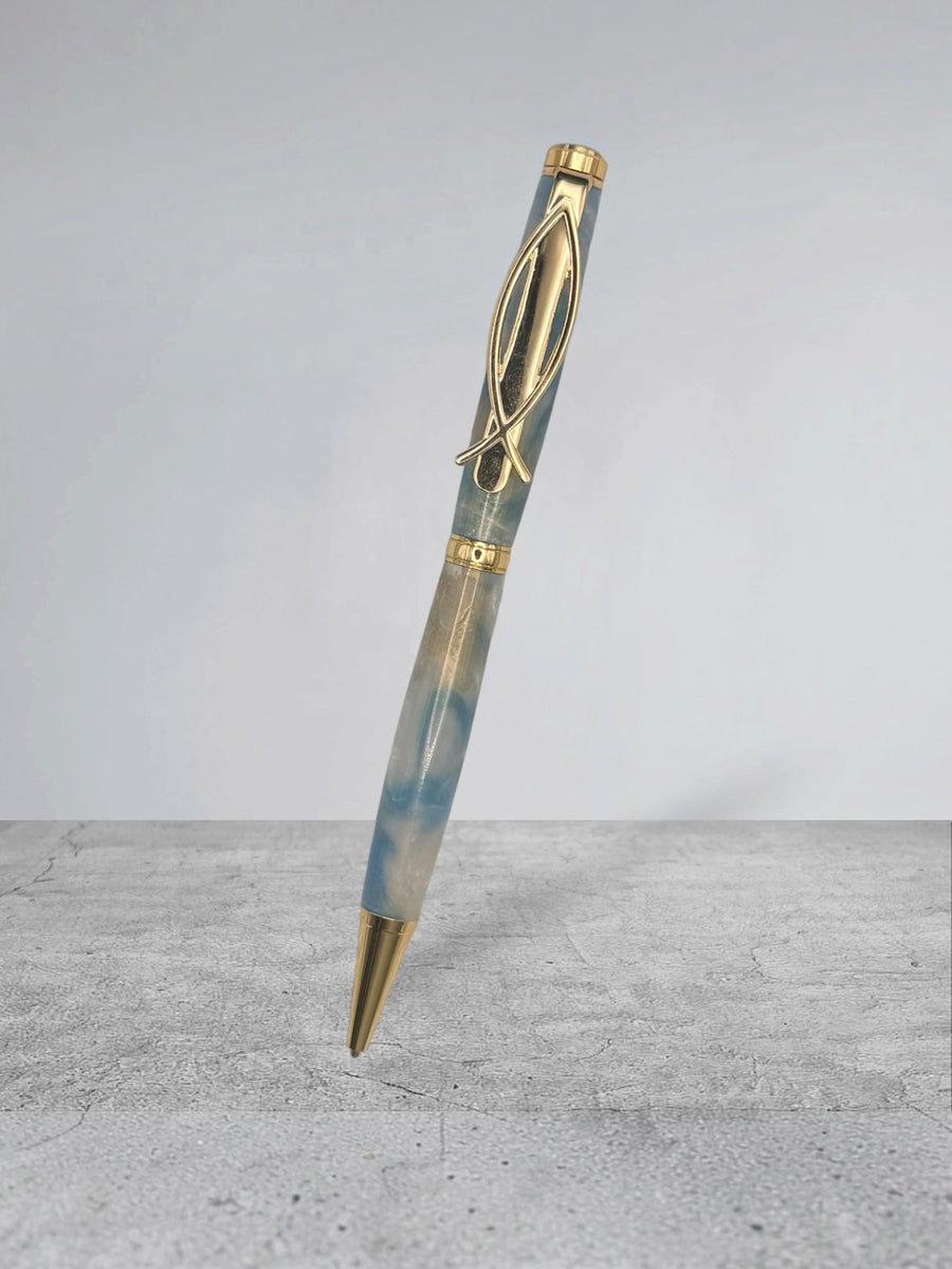 Anderson Woodworks handcrafted ballpoint pen in blue and cream marbled resin with polished gold-tone metal accents.