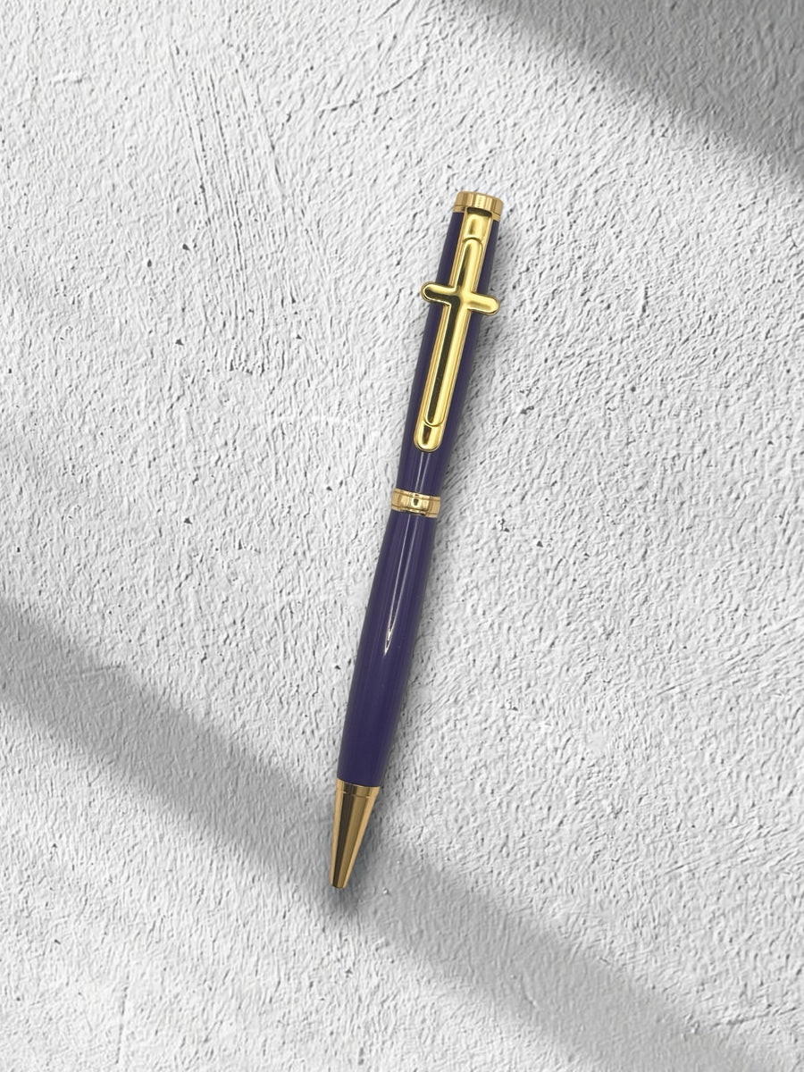 Anderson Woodworks handcrafted ballpoint pen in deep purple with gold-tone accents and a cross-shaped clip.