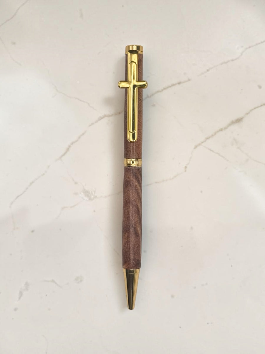 Anderson Woodworks handcrafted wooden writing pen with a gold-tone cross clip and polished gold accents